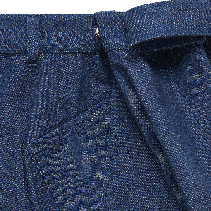 Close-up of blue adjustable waist jeans showing front pocket, belt loop and adjustable tie waist.
