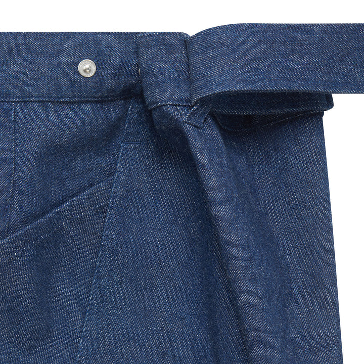 Close-up of dark blue women's jeans with adjustable waistband featuring a button and belt detail.